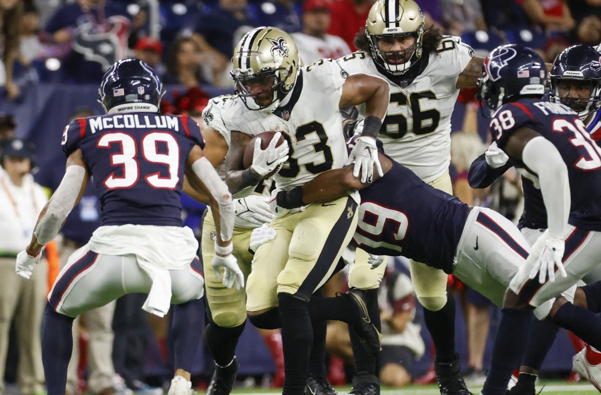 New Orleans Saints running back Abram Smith (33) runs as Houston Texans linebacker Tae Davis (19) attempts to make a tackle. Mandatory Credit: Troy Taormina-USA TODAY 